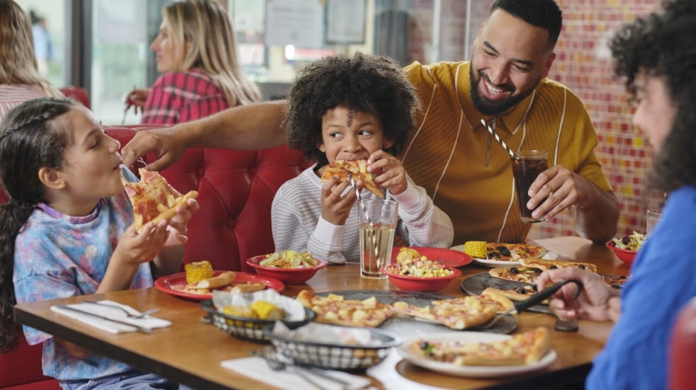 Family eating pizza at a restaurant